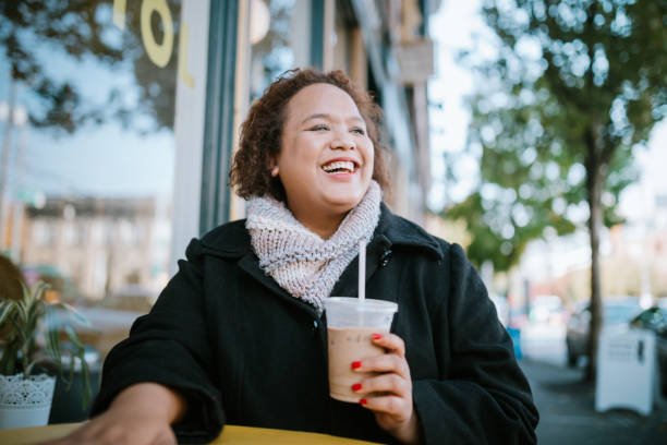 Woman Working on Laptop Outside Coffee Shop