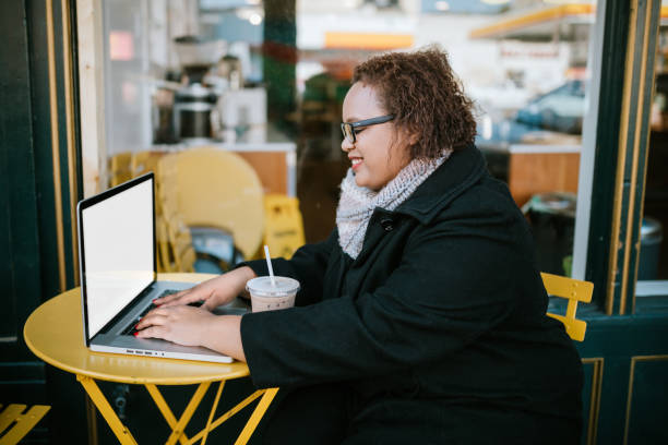 istock Woman Working on Laptop Outside Coffee Shop 1280757061