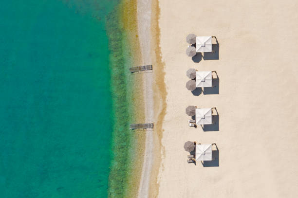 istock Beach chairs with umbrellas and beautiful sand beach 1280759234