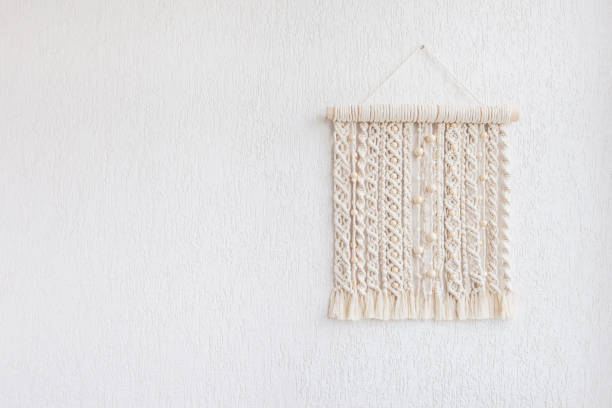 istock Macrame wallhanging with wooden beads. Wall panel of cotton threads in natural color. Macrame technique for eco home decor. Modern macrame wall hanging will add cozy atmosphere. Copy space 1280759396