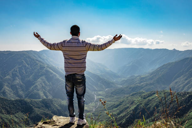 istock man watching the beautiful mountain range from edge of mountain 1280763934