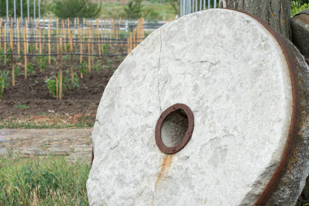 istock Old millstone for the mill. Large stone round millstone. 1280766152
