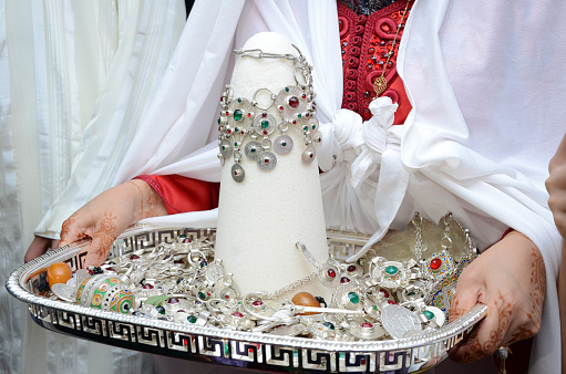 Moroccan wedding. A woman holds a pyramid of sugar.