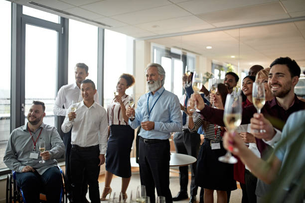 grupo diverso de empresarios tostando con champagne - fiesta en la oficina fotografías e imágenes de stock