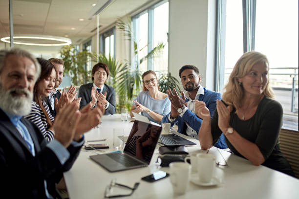 istock Diverse Executive Team Applauding Presentation in Board Room 1280766953