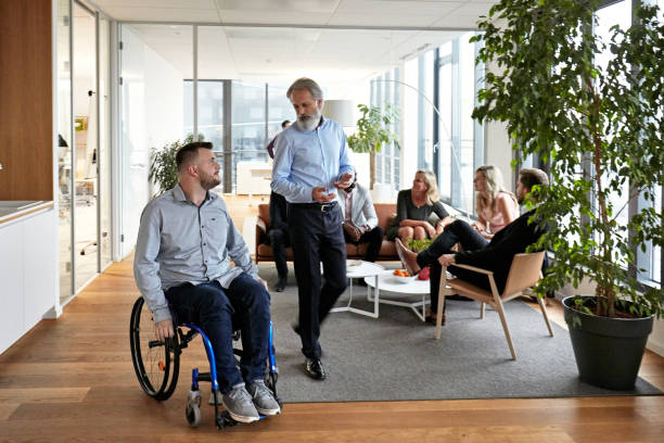 istock Businessmen in 20s and 40s Moving Through Lobby and Talking 1280766968