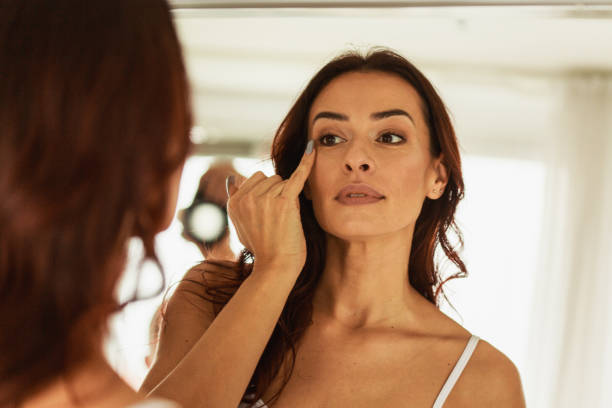 istock Woman checking her line expressions in front of the mirror 1280767033