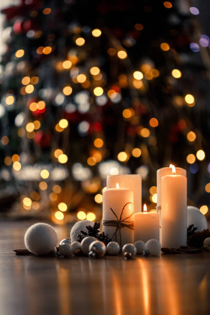 Warm decorations for the best season of the year Still life of white decorations for Christmas season placed on the floor of a cozy house in front of Christmas tree. Slective Focus stock pictures, royalty-free photos & images