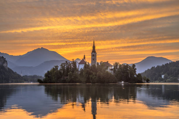 istock Lake bled with church during orange morning sky 1280767445