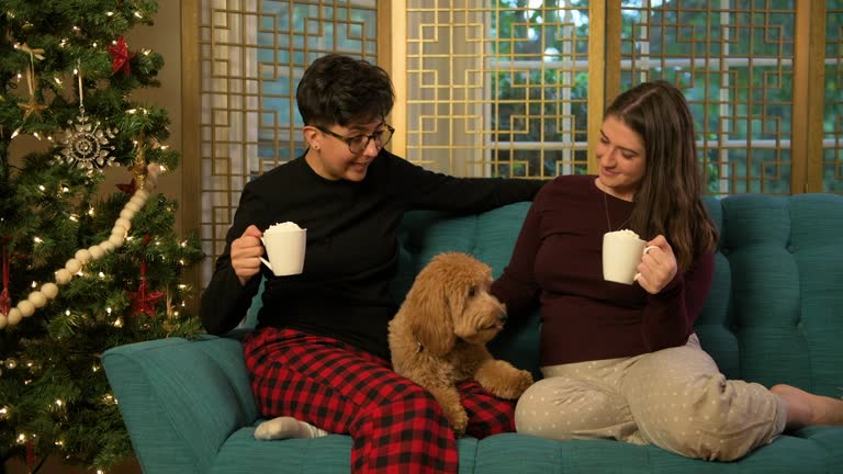 Two Women Celebrating Christmas with Their Puppy and Hot Cocoa