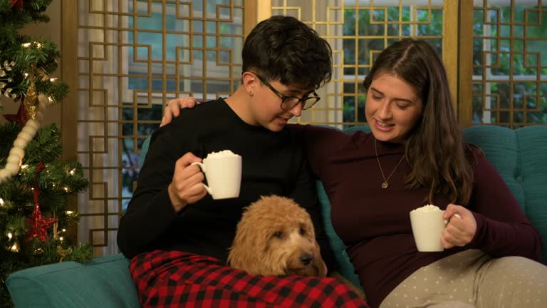 Two Women Celebrating Christmas with Their Puppy and Hot Cocoa