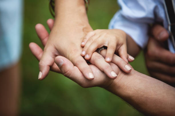 Hand in hand family as the greatest security Hand in hand family as the greatest security family holding hands stock pictures, royalty-free photos & images