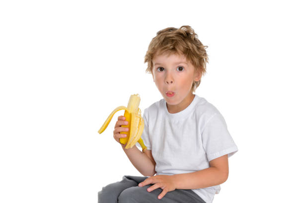 istock Boy chews a ripe and delicious banana 1280770958