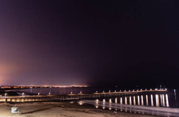 istock Twinkling stars over beach pier. 1280771101