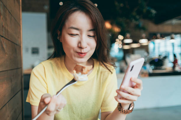 istock Asian woman eating breakfast 1280771358