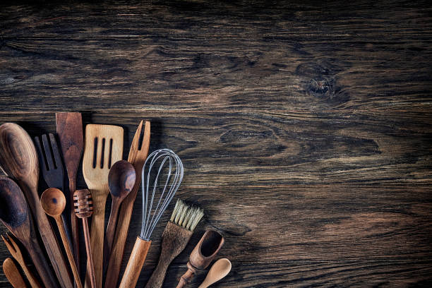 istock Top view of wooden kitchen utensils on rustic table with copy space. 1280772293