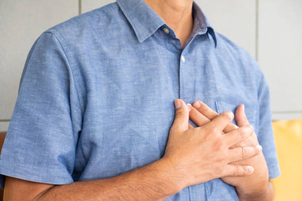 istock Selective focus at hand. Senior Asian men with chest pain suffering from heart attack inside of the house. Healthcare and medical concept, 1280772335