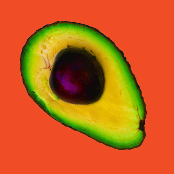istock Bright colored avocado cut in half isolated on lush lava background 1280774510