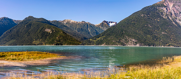 Mount Pootlass with its hanging glacier above the abandoned Talheo Cannery near Bella Coola , Canada.