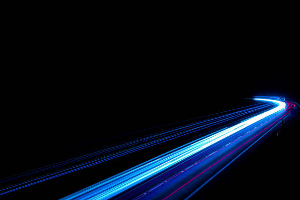 Light trails on road. High speed driving makes abstract light trails at dusk.