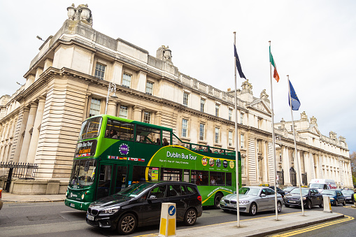 Dublin, Ireland - 10 November 2015: Bus and cars outside Department of the Taoiseach ,the title of the deputy prime minister at Government Buildings, Merrion Street
