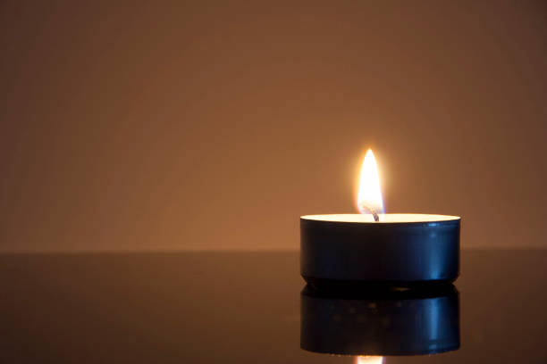 istock Closeup of a peaceful burning tea light. Remember. 1280777969