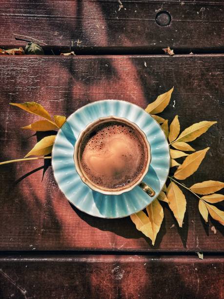 A cup of turkish coffee with autumn leaf on wood table