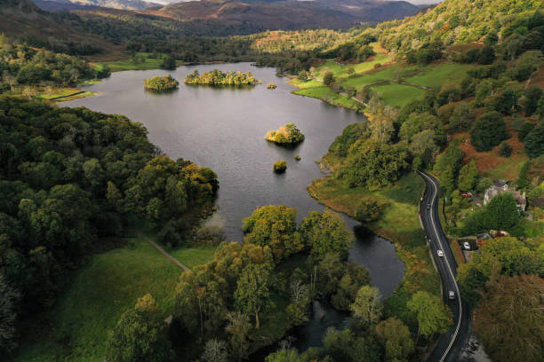 Aerial landscape of Rydal Water and Grasmere in the Lake District National Park, UK An aerial landscape by drone of Rydal Water lake towards Grasmere in the Lake District National Park, UK during Summer or Fall english lake district stock pictures, royalty-free photos & images