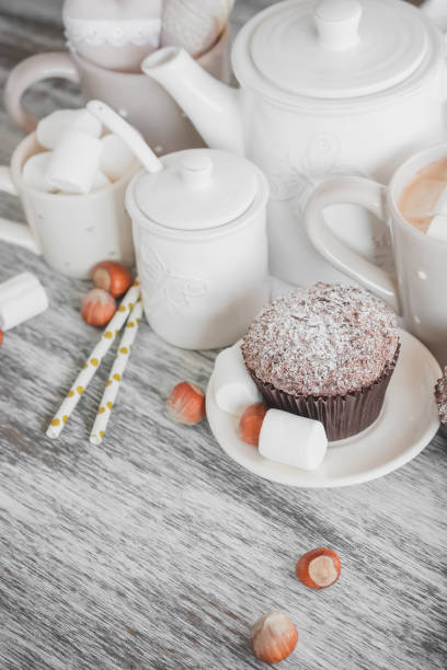 istock Cups with cacao and marshmallow, cupcakes and different decorations 1280784444