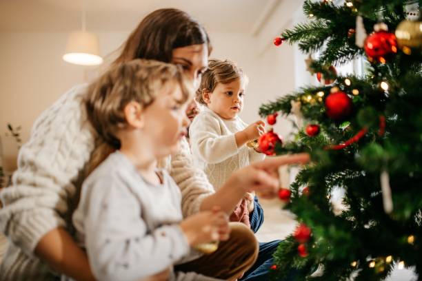 istock Family with kids decorating Christmas tree 1280787736