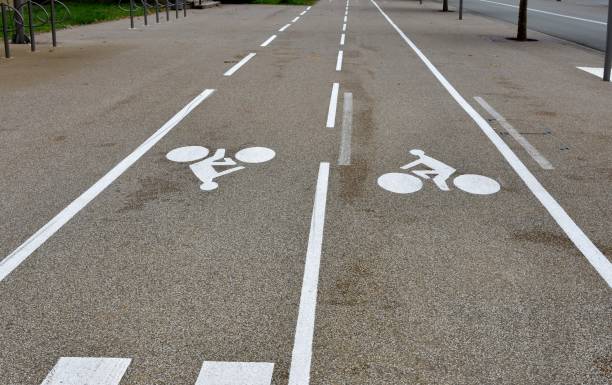 bike lanes or cycle paths in opposite directions along the car road in the city of belfort in france. - belfort imagens e fotografias de stock