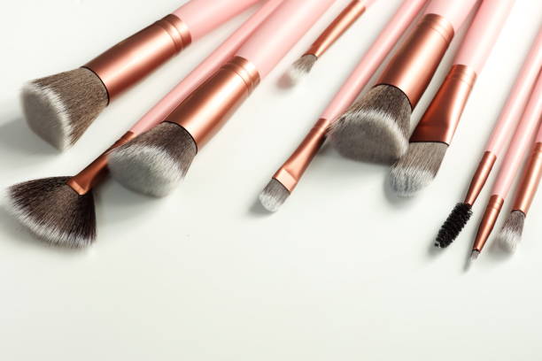 istock makeup brushes set pink color on white background close up. Top view. copy space. Beauty background. 1280788510