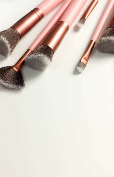 istock makeup brushes set pink color on white background close up. Top view. copy space. Beauty background. 1280788650