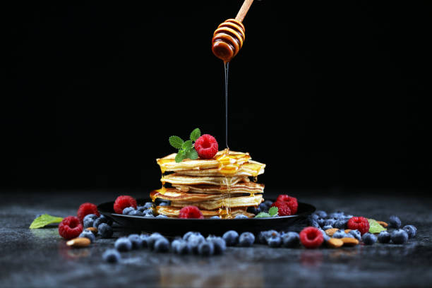 istock Homemade crepes served with fresh raspberrries and powdered sugar on rustic table. 1280788834