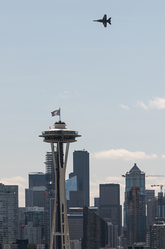 Seattle, USA - August 1, 2019: The famous US Navy’s Blue Angels flying in formation past a packed sky deck at the Space Needle mid day in their Boeing F/A- 18 Hornets during the annual Seafair show over Lake Washington. The Blue angels fly with such precision that their wingtips are less than 50 inches apart.