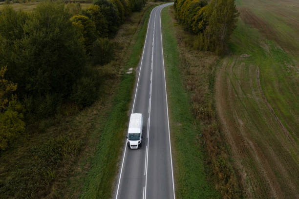 istock A white camper van drives on an asphalt road. Aerial view. 1280790605