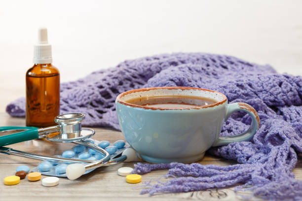istock Hot tea, pills, knitted scarf and stethoscope. 1280791057