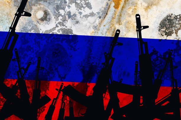 istock Several automatic rifles raised up on the background of the Russian flag 1280792107
