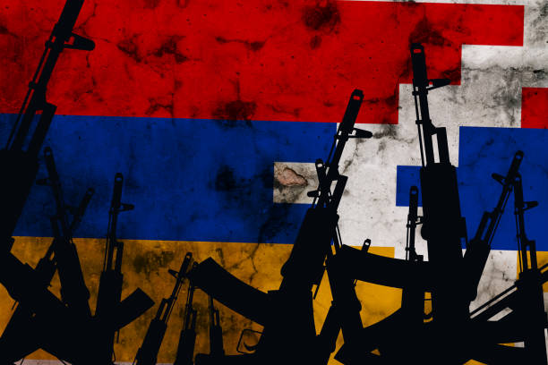 istock Several automatic rifles raised up on the background of the Karabakh flag 1280792117