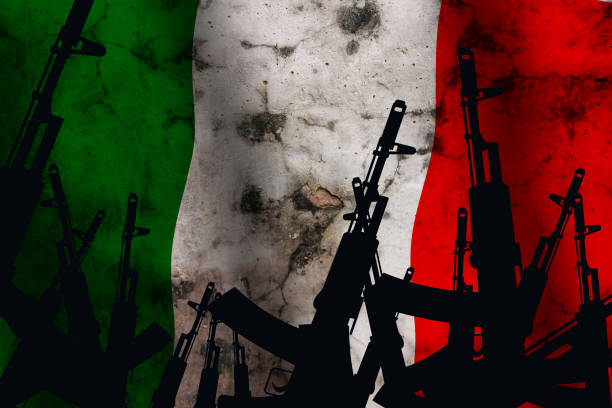 istock Several automatic rifles raised up on the background of the Italy flag 1280792124