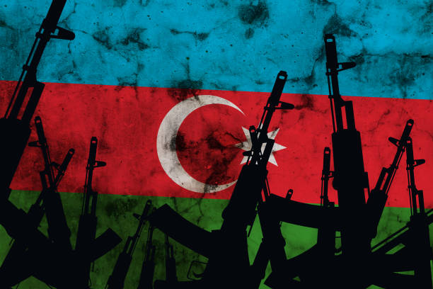 istock Several automatic rifles raised up on the background of the Azerbaijan flag 1280792338