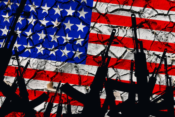 istock Several automatic rifles raised up on the background of the American flag 1280792476