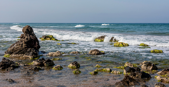 Rocky coastline and waves on the beach in Turkey.