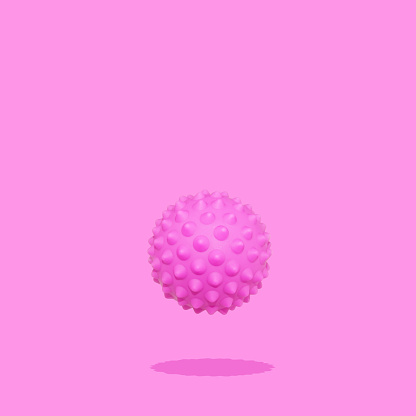 This is a spiny ball or corona virus trendy conceptual photo on pink background.