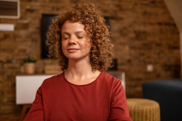 istock Young woman meditating at home. 1280799860