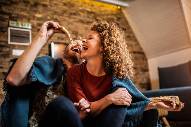 Young couple eating pizza.