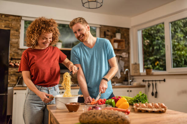 istock Young couple preparing food together. 1280800917