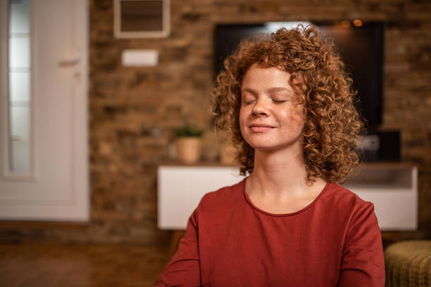 istock Young woman meditating at home. 1280801015