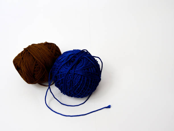 istock knit yarn in brown and blue on white background 1280803739