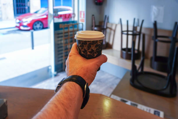 istock Waiter holding recycled cardboard cup with hot coffee to go 1280804411